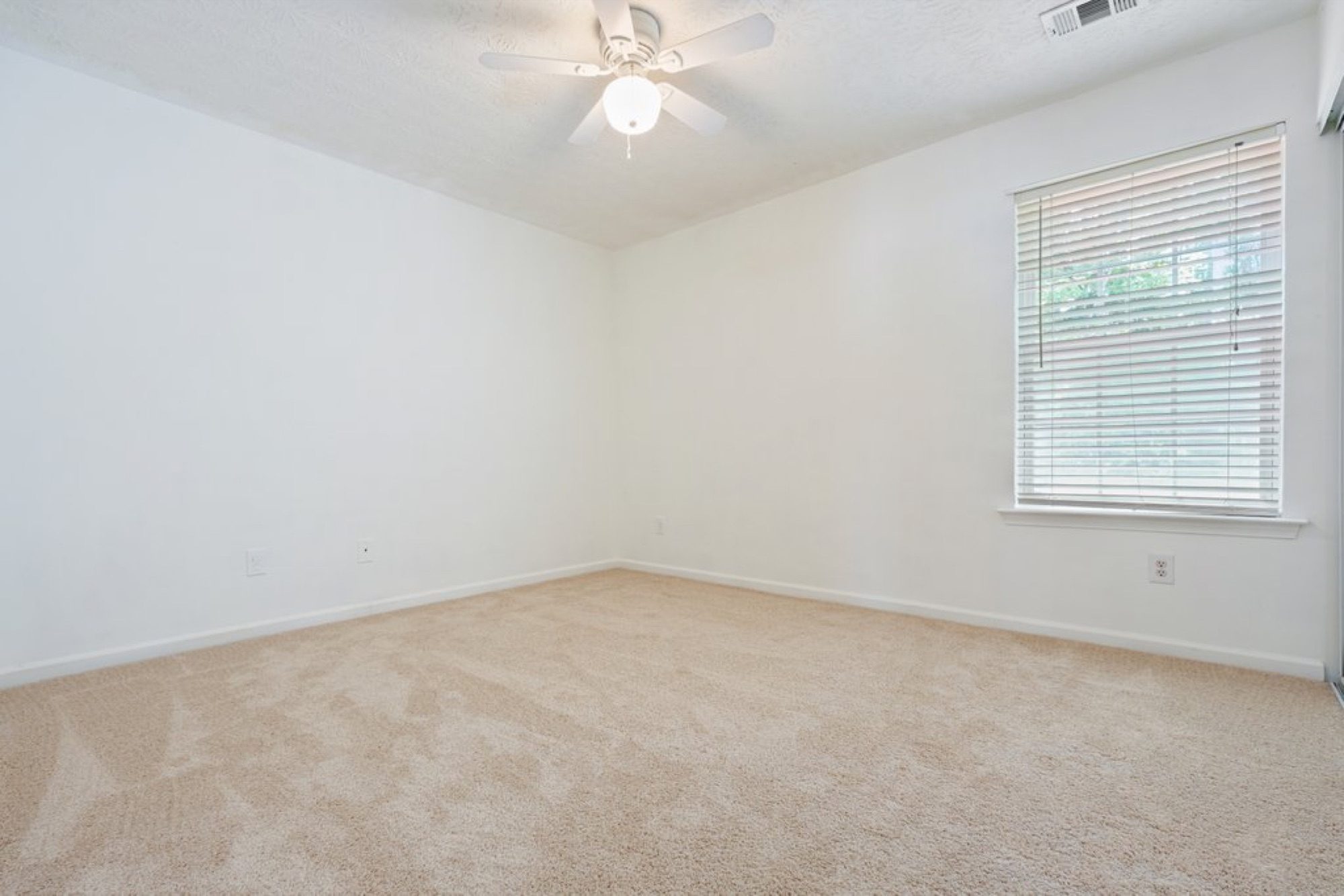 The same bedroom, empty and unstaged